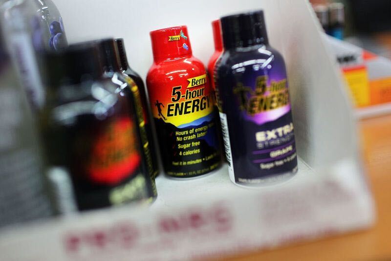 A collection of energy shots bottles sits on the table.